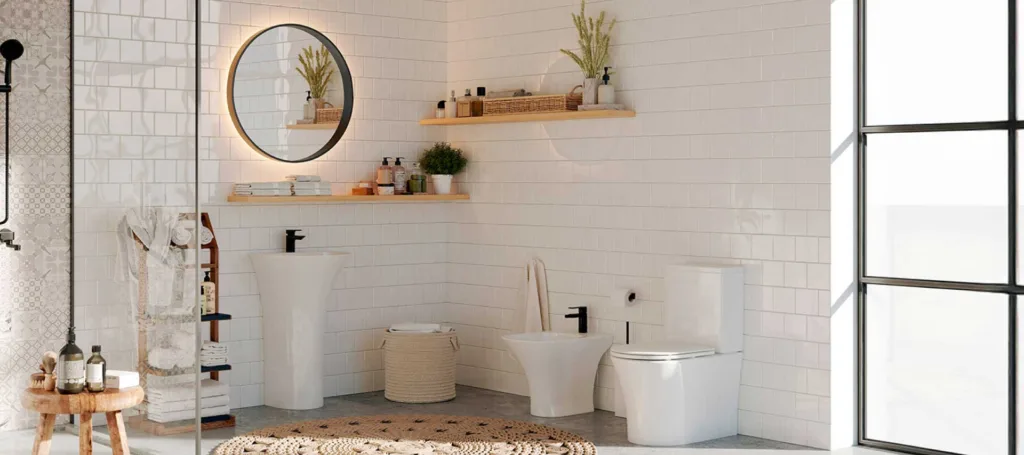 White wash hand basin in a bathroom with a wall mirror and a white toilet.