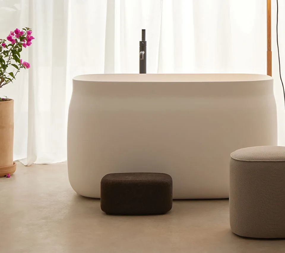 Cream bathtub with black tap