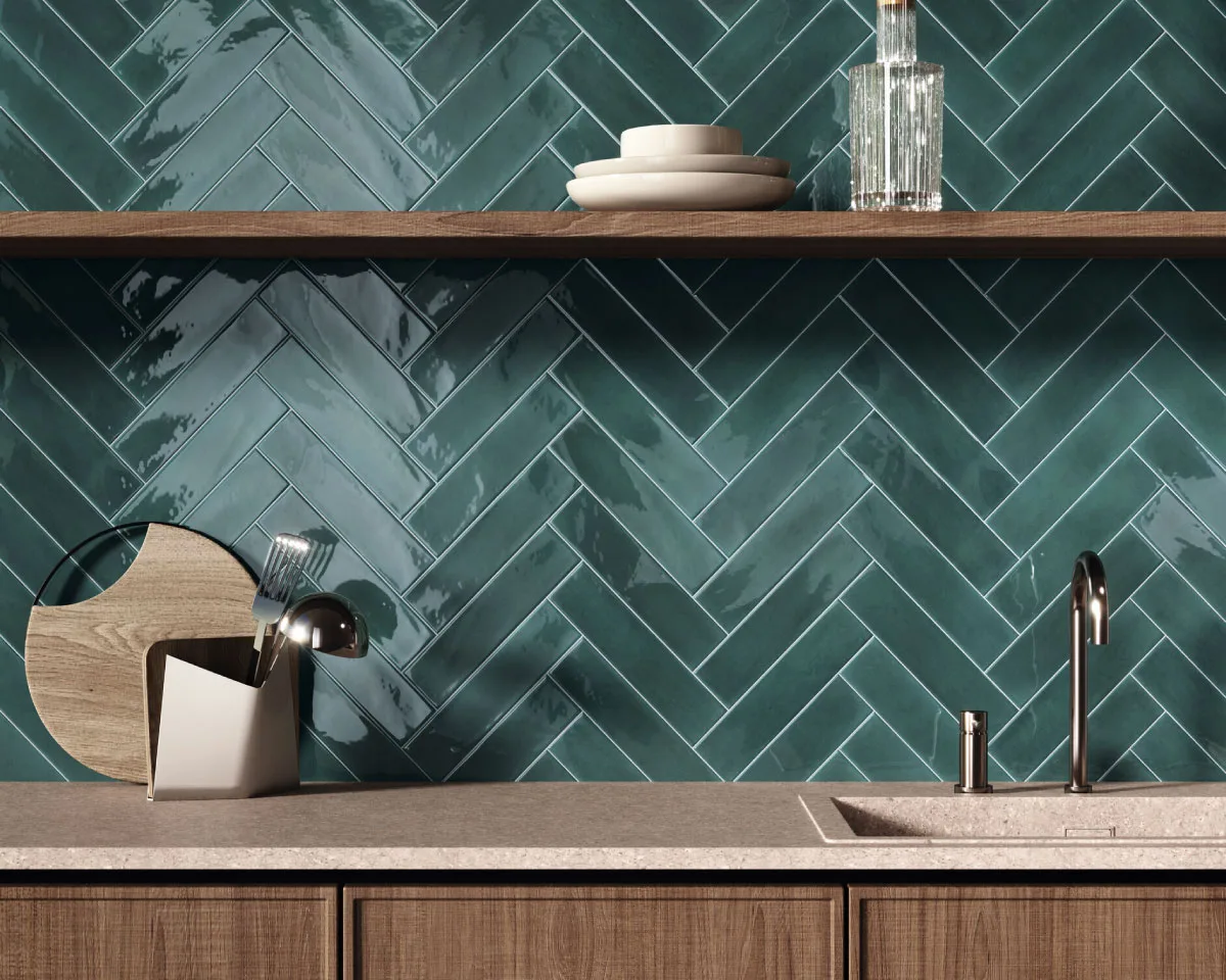 Modern kitchen featuring a glossy green chevron tile backsplash, adding texture, depth, and contemporary elegance.