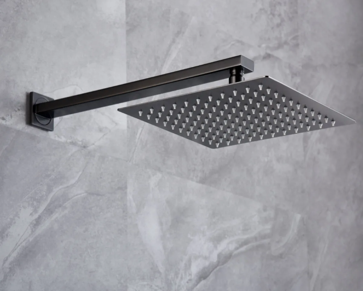 Matte black square rain shower head with wall-mounted arm installed on grey stone-effect bathroom tiles, adding a sleek and contemporary touch to modern shower spaces.