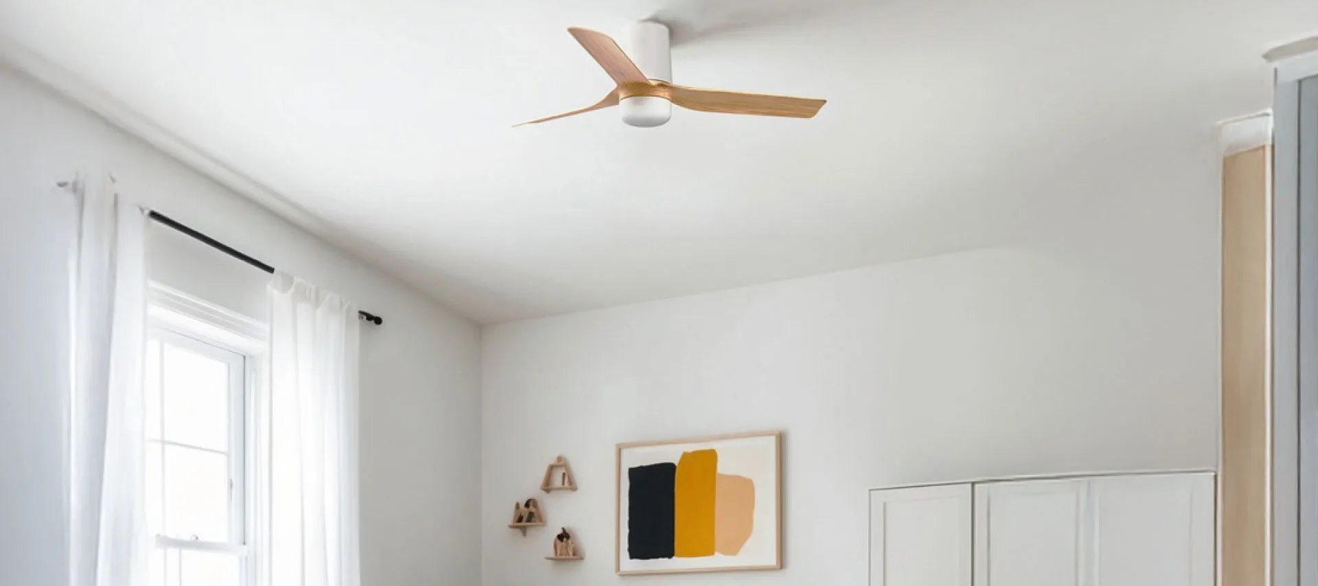 Modern white ceiling fan with wooden blades installed in a bright contemporary living room